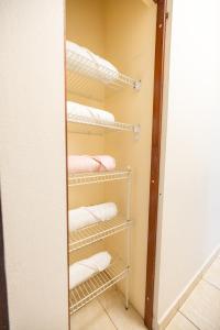 a walk in closet with white towels on shelves at Arenales Guest House in Isabela +25 photos