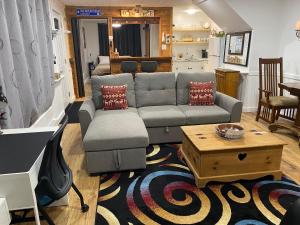 a living room with a couch and a coffee table at Our Place Up North BnB in Huntsville