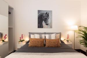 A bed or beds in a room at Spiga Duplex Suites by Montenapoleone Living