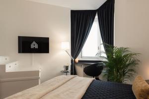 A bed or beds in a room at Spiga Duplex Suites by Montenapoleone Living