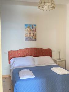 a bedroom with a bed with a red headboard at Positano's Flats in Positano