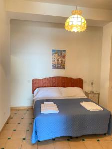 a bedroom with a bed and a chandelier at Positano's Flats in Positano