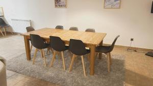 a wooden table with black chairs around it at Tarter Mountain Lofts in El Tarter