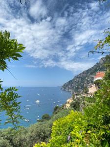 a view of the ocean from a hill with boats at Positano's Flats in Positano