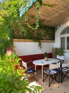 a patio with a table and chairs under a roof at Positano's Flats in Positano