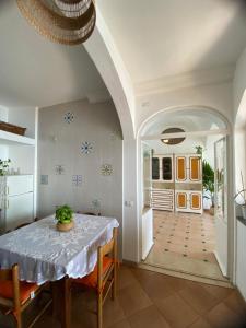 a dining room with a table and chairs and a hallway at Positano's Flats in Positano