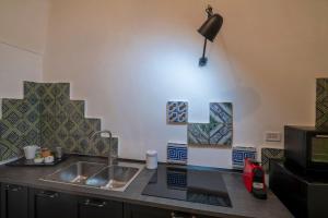 A kitchen or kitchenette at Corte dei Romiti Apartment - Lecce Selection