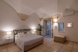 A bed or beds in a room at Corte dei Romiti Apartment - Lecce Selection