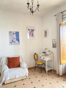 a living room with a couch and a desk at Positano's Flats in Positano