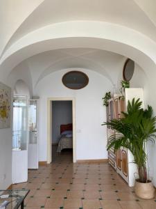 a hallway with a room with a table and a bed at Positano's Flats in Positano