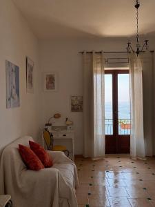 a bedroom with a bed and a table and a window at Positano's Flats in Positano +36 photos