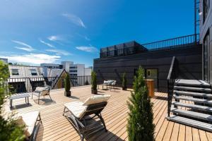 a deck with chairs and tables on top of a building at Bob W Tallinn City Centre - Avangard in Tallinn