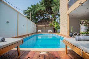a swimming pool on a patio with a house at Il Nido Cotonou in Cotonou