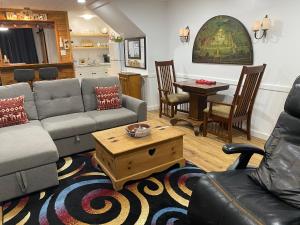 a living room with a couch and a table at Our Place Up North BnB in Huntsville
