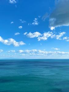 a view of the ocean with a blue sky and clouds at Positano's Flats in Positano