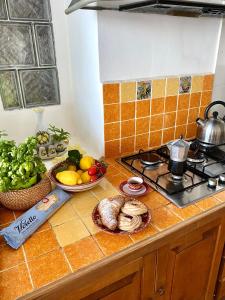 a kitchen counter with fruits and vegetables and a stove at Positano's Flats in Positano