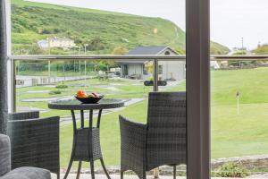 a view of a patio with a table and chairs at Sandcastles 11 Europa Court in Mawgan Porth in Mawgan Porth
