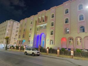 a car parked in front of a building with colorful doors at اجنحة روتانة الفرسان بالحمرا in Jeddah