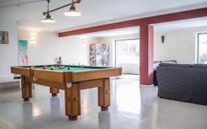 a living room with a pool table in it at Liv In by Ericeira Property in Santo Isidoro