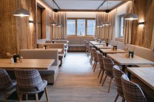 a row of tables and chairs in a restaurant at Obertrauner Hof in Obertraun