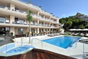 a hotel with a swimming pool in front of a building at Vincci Selección Aleysa in Benalmádena