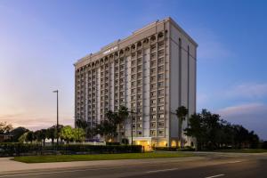 a large white building on the side of a street at Crowne Plaza Orlando-Downtown by IHG in Orlando