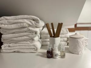 a pile of towels on a bathroom counter with a stack of towels at Casa Francesca in Mogliano Veneto +46 photos