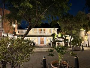 a house at night with a courtyard with trees at The Raden Patah Heritage Kota Lama Semarang in Semarang