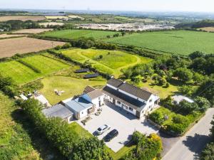 an aerial view of a house in a field at The Sty, rural retreat for couples in Falmouth