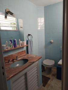 a bathroom with a sink and a toilet at Mônaco 301 in Niterói +17 photos