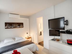 a bedroom with a bed and a flat screen tv at FRGK FR - Surcouf "PALM BEACH " in Cannes