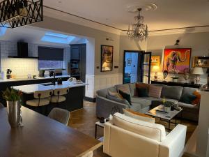 a living room with a couch and a table at East Cliff in Preston