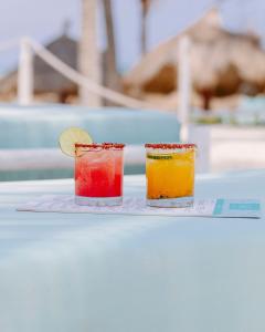 two colorful cocktails on a plate on a table at Villa Casa Agua in Akumal