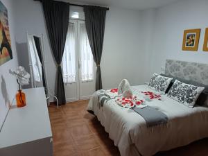 a bedroom with a bed with flowers on it at La casa de mayfer in Benamahoma +17 photos