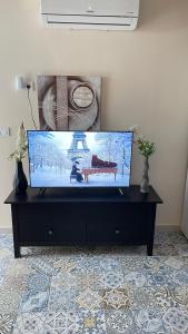 a flat screen tv sitting on top of a black entertainment center at Luxury Estudio CH&H in Benalmádena
