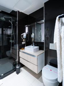 a bathroom with a sink and a toilet at The Fourteen Luxury Boutique Hotel in Casablanca +52 photos