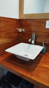 a white sink on a wooden counter in a bathroom at Complejo Puente viejo JMT in Trevelín +44 photos