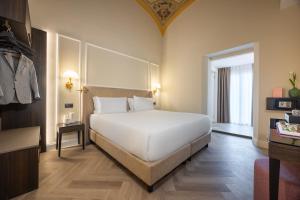 Postel nebo postele na pokoji v ubytování BH Hotel