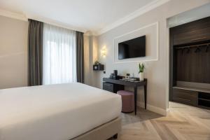 Postel nebo postele na pokoji v ubytování BH Hotel