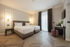 Postel nebo postele na pokoji v ubytování BH Hotel