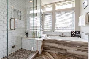 a white bathroom with a tub and a window at Luxury 5-Bedroom Home in LoHi in Denver +36 photos