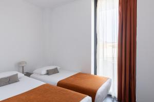 Posteľ alebo postele v izbe v ubytovaní Cosmo Apartments Sants