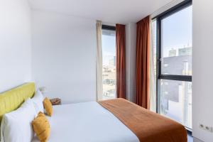 Posteľ alebo postele v izbe v ubytovaní Cosmo Apartments Sants
