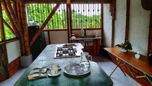 a kitchen with a counter and a table in a room at Hospedaje piedras de agua in Santa Marta