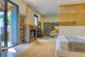 a bedroom with a fireplace and a bed in a room at Ricardo House, a Home in Madeira in Calheta