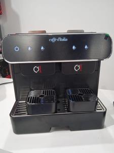a black espresso machine sitting on a table at Il mulino foresteria in Parona
