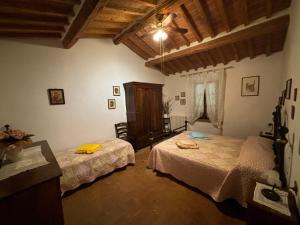 a bedroom with two beds in a room at CASE&COLLINE Podere S'Ignazio in Montescudaio +36 photos