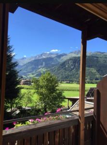 a view from the balcony of a house with flowers at Winklgut Bacher in Uttendorf