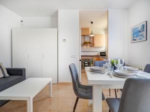 a white dining room with a white table and chairs at Ribes Duplex by Hello Homes Sitges in Sitges