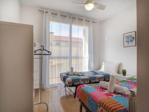 a bedroom with two beds and a window at Ribes Duplex by Hello Homes Sitges in Sitges